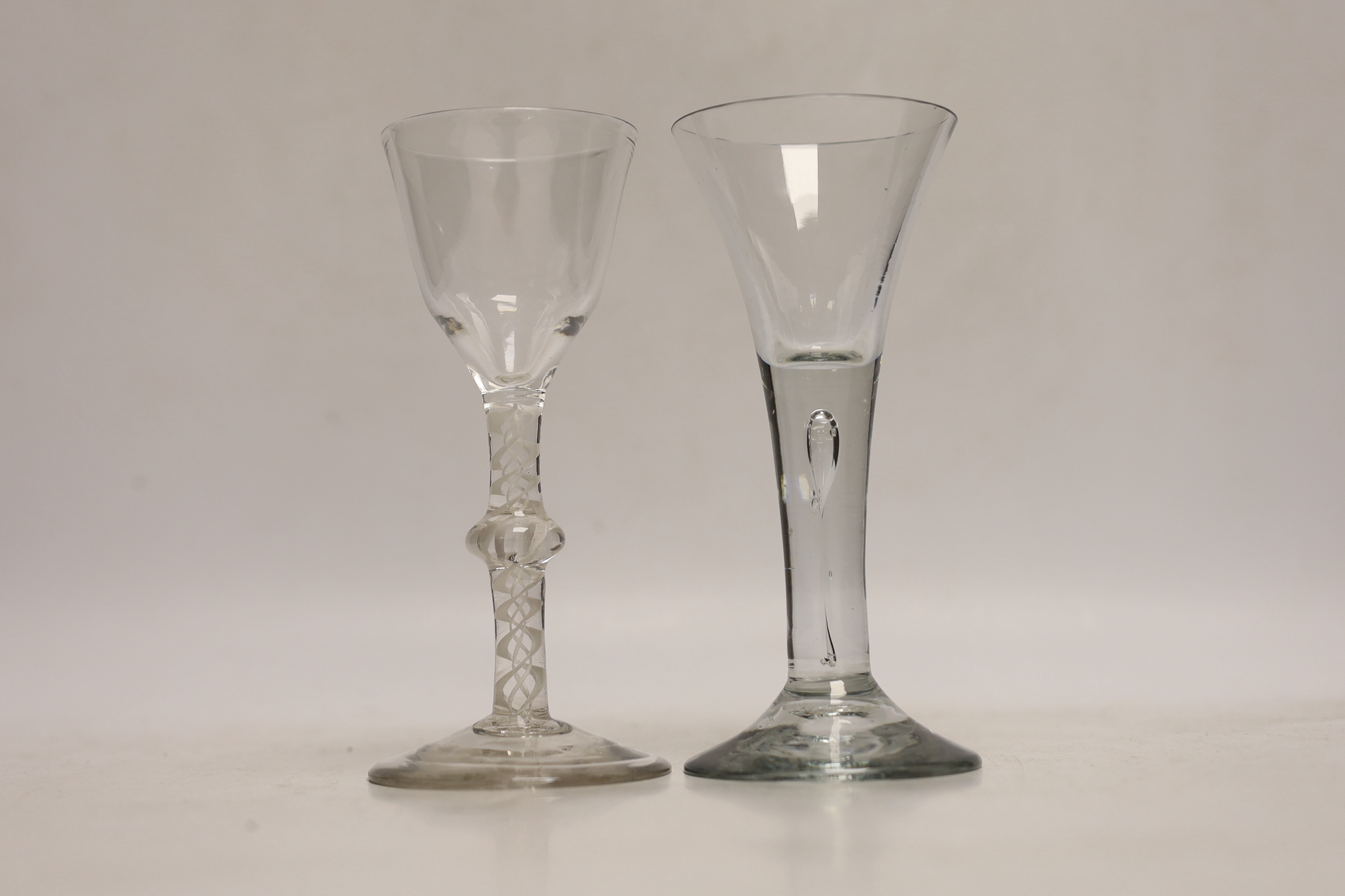Two Georgian drinking glasses comprising, c.1760 opaque twist cordial glass and c.1750 drawn trumpet example, each 16cm high